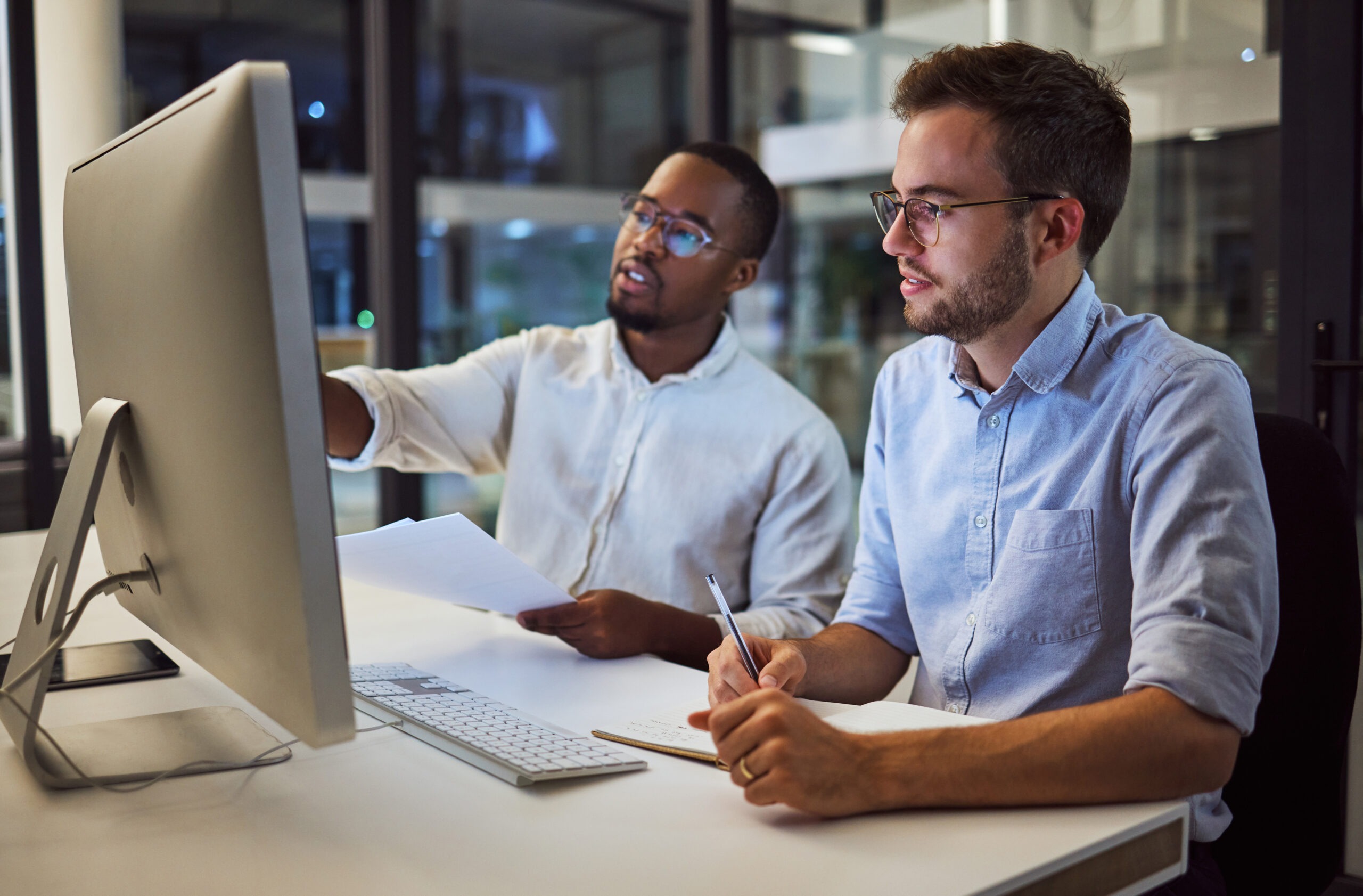 Business meeting, marketing at night with computer or teamwork planning, collaboration or innovation strategy in startup company. Diversity, working online or research for partnership deal proposal.